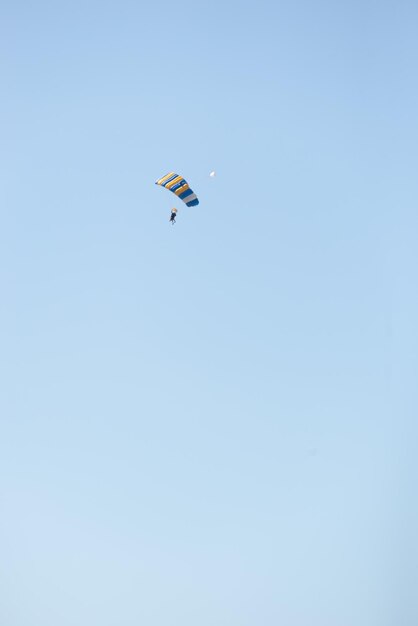 Parachutiste volant dans Blue SkyVertical ImageCopy Space