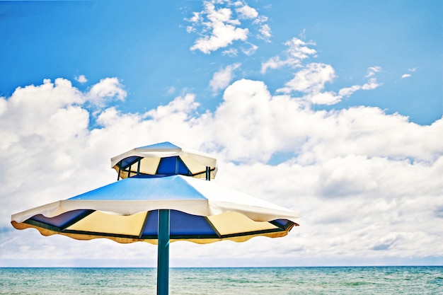 Parasol sur une journée ensoleillée. Parasol blanc avec un ciel bleu.