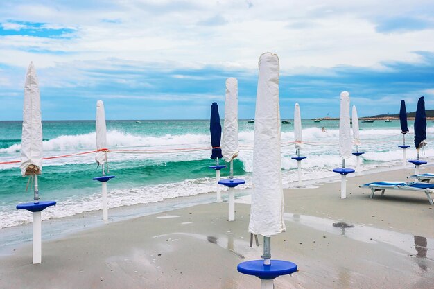 Parasols blancs ar plage de La Cinta à San Teodoro, Sardaigne, Italie