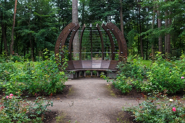 Un parc forestier avec de grands arbres et des bancs et des arches créatives.