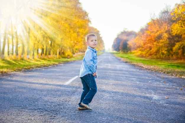 Un parent heureux avec enfant marchent le long de la route dans le parc lors d'un voyage dans la nature