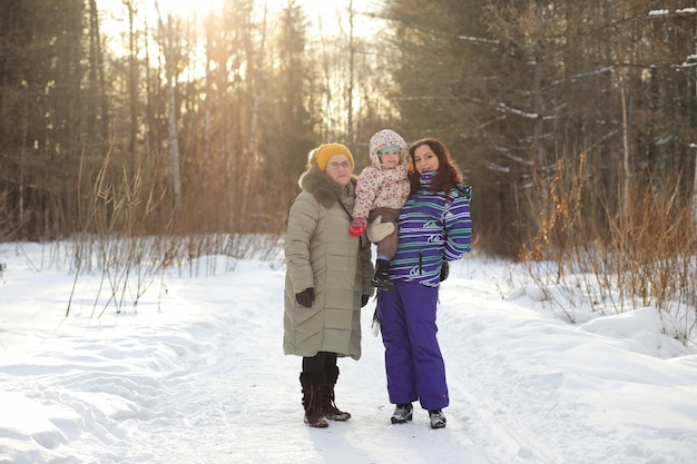 Parent tenant un enfant sur les mains dans le parc d'hiver