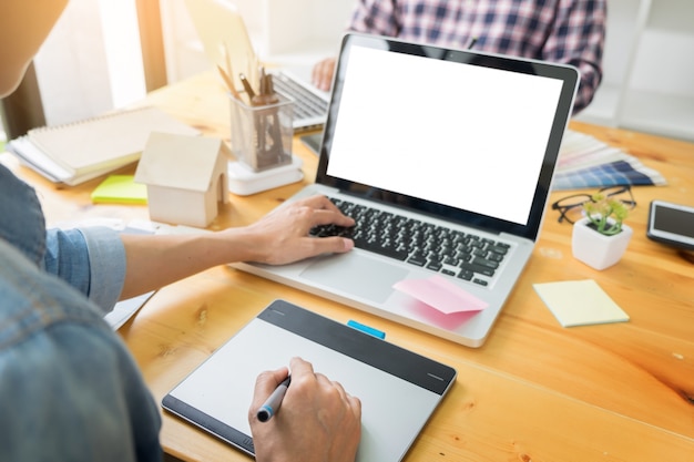 Les partenaires de conception graphique travaillent ensemble à la rénovation et au concept de technologie - sur un ordinateur de bureau et une sélection en utilisant des échantillons de couleurs.