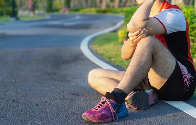 La partie inférieure de la femme assise sur le trottoir