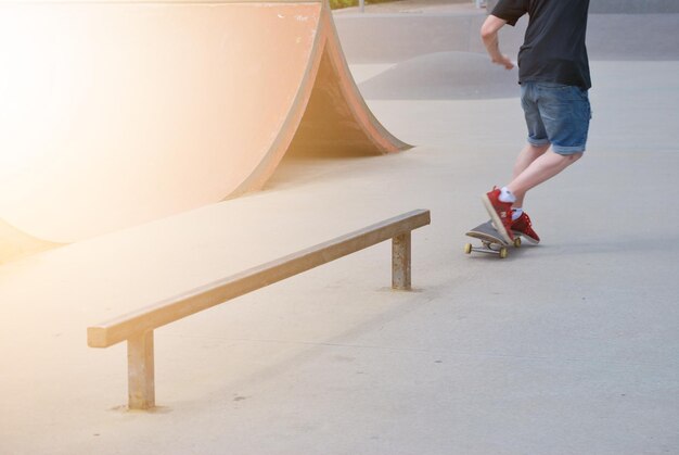 Photo la partie inférieure de l'homme sur le skateboard dans le parc