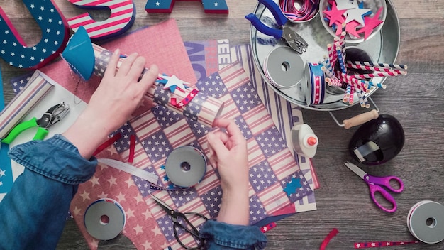 Pas à pas. Mère et fille fabriquant des pétards en papier pour la célébration du 4 juillet.