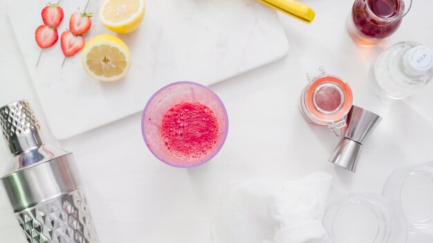 Pas à pas. Préparation d'un cocktail de bourbon Kentucky Kiss avec des fraises biologiques fraîches.