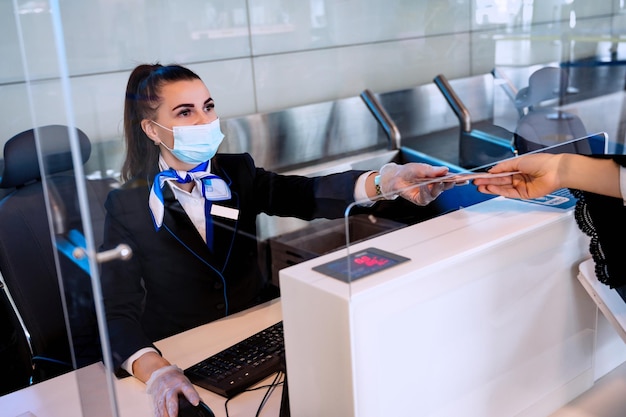 Passager remettant ses documents d'enregistrement au directeur de l'aéroport au comptoir