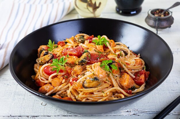 Photo pasta de fruits de mer avec palourdes de saumon et de tomates spaghetti avec cocktail de fruits de mer