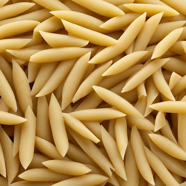 Photo pasta de penne crue non cuite vue supérieure de la nourriture italienne