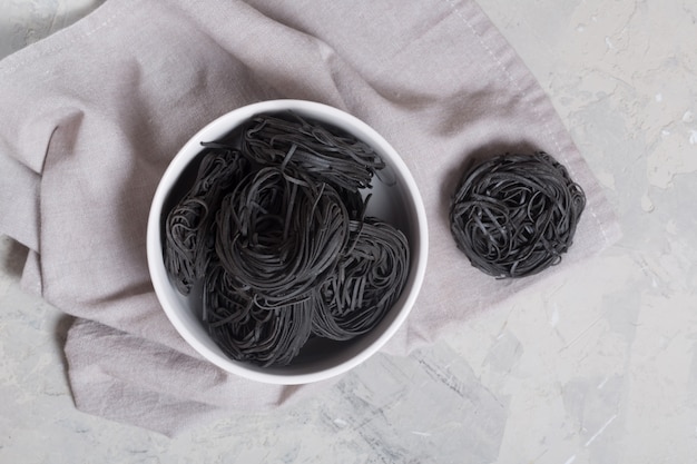 Pâtes capellini italiennes sur la table grise