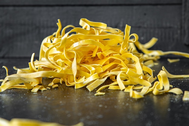 Pâtes crues cuisine maison tagliatelles faites à la main blé dur collation repas frais sur l'espace de copie de table