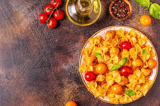 Pâtes servies avec boulettes de poulet et sauce tomate