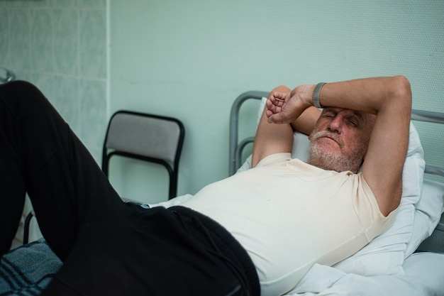 Patient âgé se reposant sur le lit à l&#39;hôpital