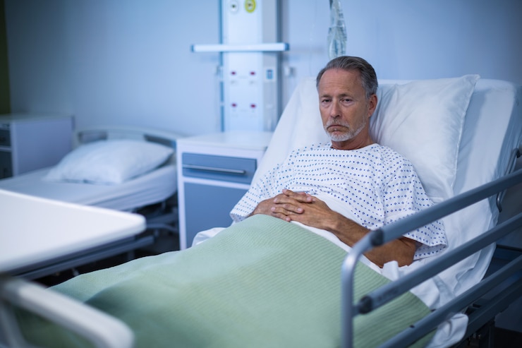 Photo patient malade assis sur le lit