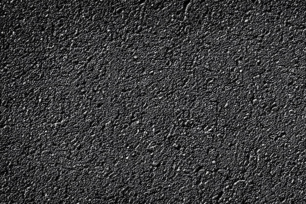 Pavé d'asphalte abstrait fond monochromatique texturé brillant