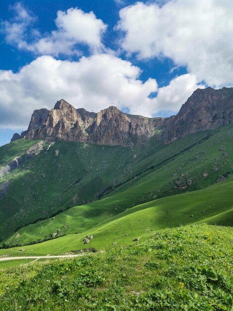 Le paysage du col vert d'Aktoprak dans le Caucase la route et les montagnes sous les nuages gris Russie