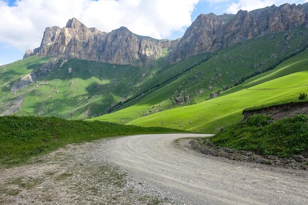 Le paysage du col vert d'Aktoprak dans le Caucase la route et les montagnes sous les nuages gris