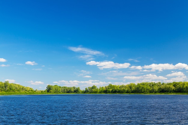 Paysage d'été avec lac forestier et ciel bleu