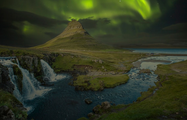 Paysage de Kirkjufellsfoss la nuit avec de belles aurores boréales. Islande