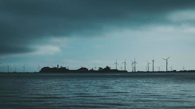 Paysage marin avec île et moulins à vent en arrière-plan