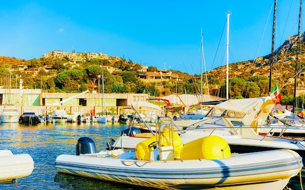 Paysage avec Marina et yachts de luxe à la mer Méditerranée de Porto Cervo en Sardaigne île d'Italie en été. Vue paysage sur le port de la ville sarde avec navires et bateaux en Sardaigne. Technique mixte.