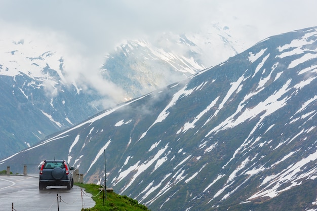 Paysage de montagne couvert nuageux au printemps (col de l'Oberalp, Suisse). Le modèle de voiture est méconnaissable.