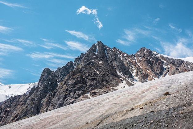 Paysage de montagne pittoresque avec glacier sous des rochers pointus au soleil Paysage impressionnant avec langue glaciaire et pinacle rocheux au soleil Belle vue sur les montagnes enneigées à très haute altitude