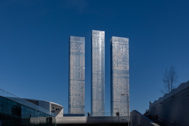 Paysage urbain moderne avec trois grands gratte-ciel étroits contre le ciel bleu clair Moscou Russie