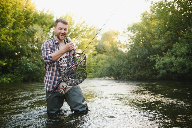 Pêche Pêcheur et truites Pêcheur sur rivière sauvage