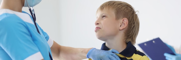 Pédiatre femme écoutant un garçon respirant avec un outil stéthoscope rendez-vous chez le médecin