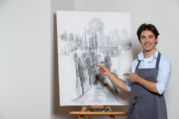 Peintre masculin posant avec son beau studio de peinture dessin de fond blanc