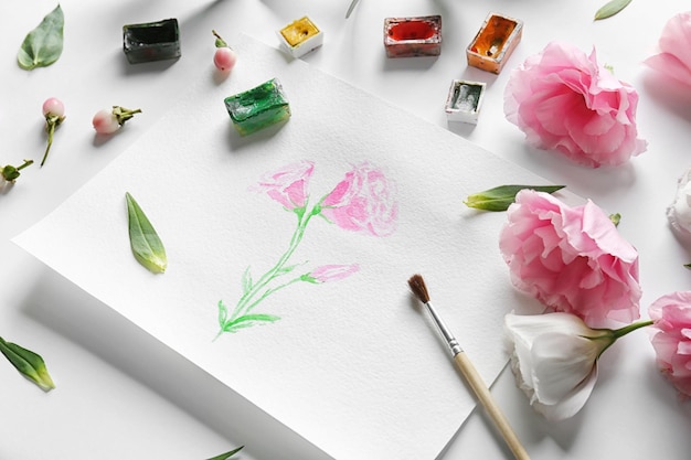 Peinture à l'aquarelle avec des fleurs sur une feuille d'album