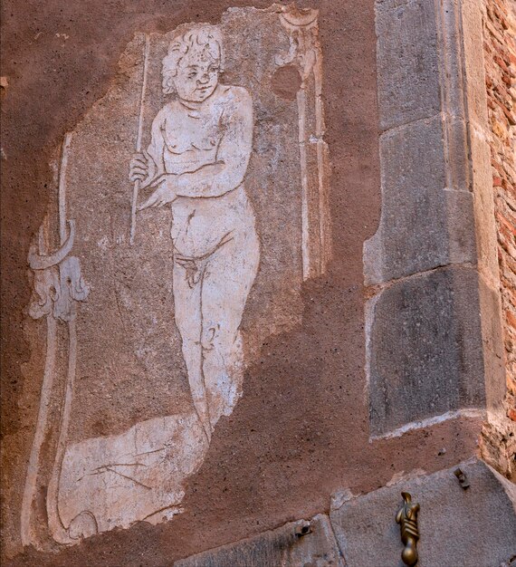 Photo une peinture d'un garçon avec une lance sur le côté d'un bâtiment.