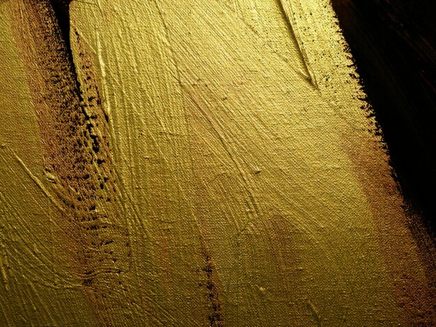 Photo peinture d'or sur fond abstrait de toile avec texture