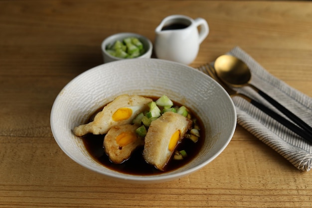 Pempek avec cuko ou sauce au vinaigre sur bol blanc