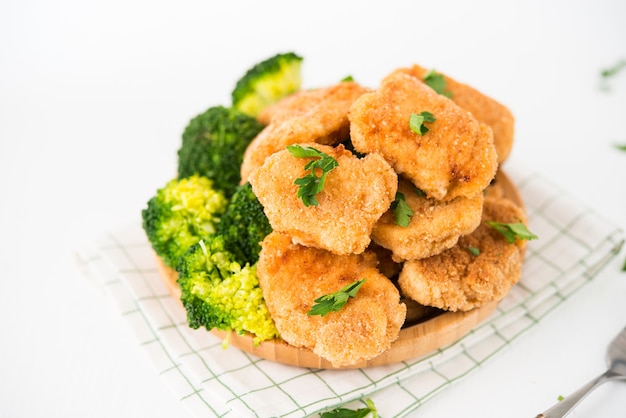 Pépites de poulet maison avec des légumes sur une assiette