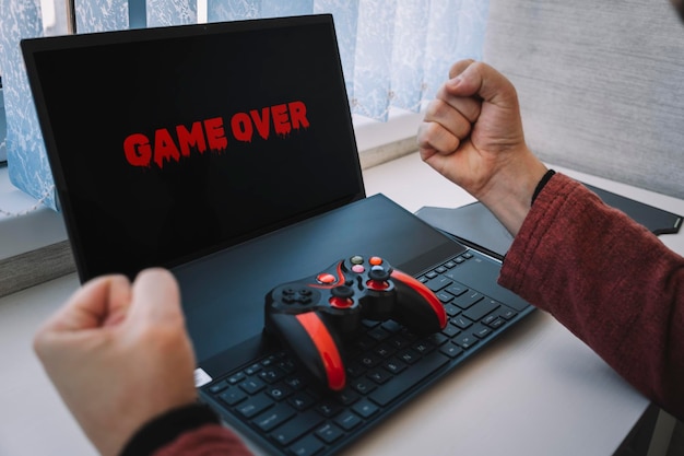 Perdre un joystick de jeu vidéo sur les gestes du clavier Game over sur l'écran de l'ordinateur portable