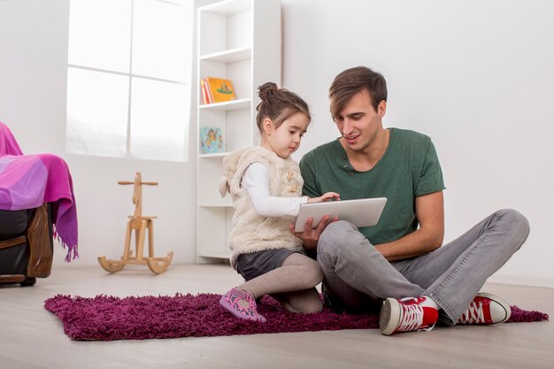 Père et fille avec une tablette