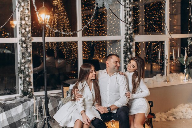 père et filles près de l'arbre de noël