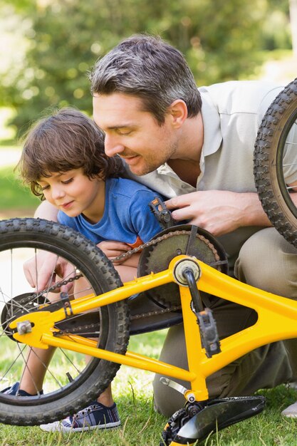 Père et fils fixant le vélo