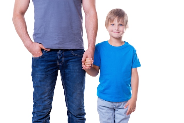 Père et fils. Père et fils se tenant la main en se tenant isolé sur blanc