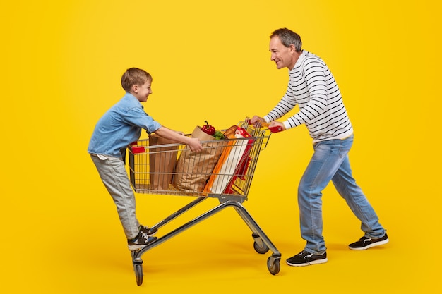 Père et fils s'amusant à l'épicerie