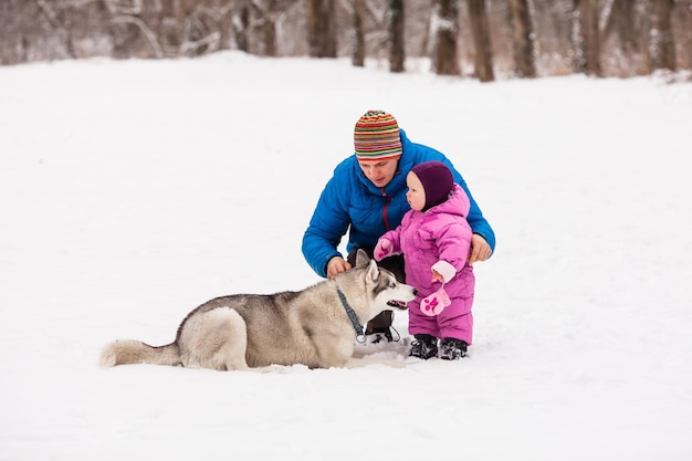 Le père montre à sa petite fille comment traiter un chien