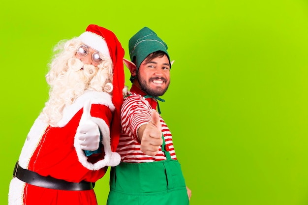 Photo père noël et elfe avec le pouce vers le haut