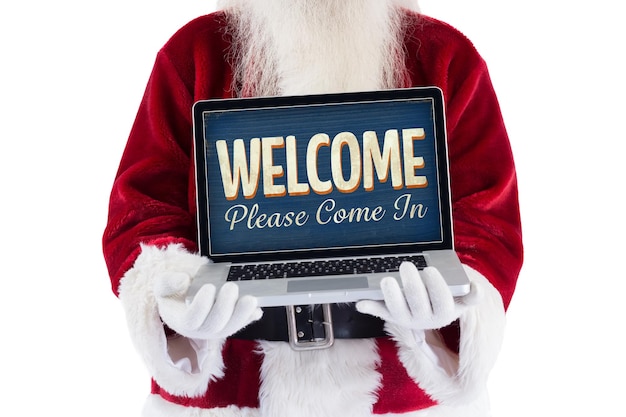 Le Père Noël présente un ordinateur portable contre un signe ouvert vintage
