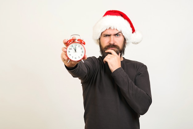 Père Noël tenant une horloge