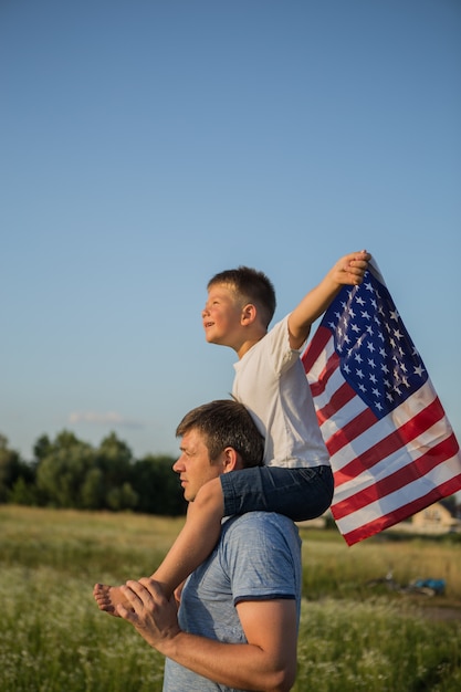 Père et petit garçon tenant le drapeau américain