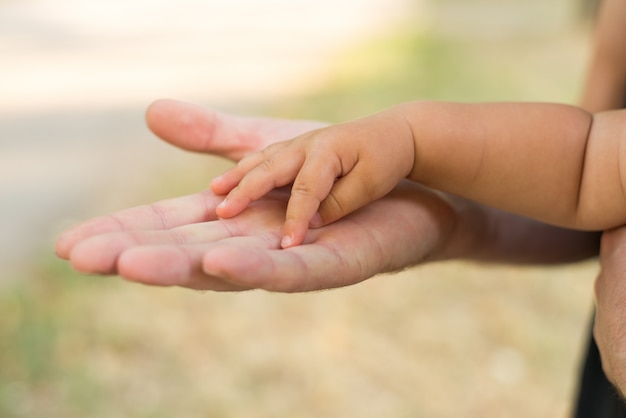 Père tenant la main de sa fille.