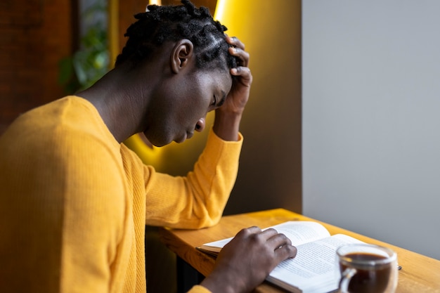 Photo personne dans un café lisant un livre